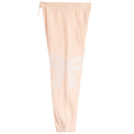 Light peach pink jogger pants featuring a white embroidered bow design on the left leg, with an elastic waistband and drawstring.
