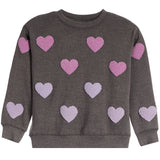 A dark gray crewneck sweatshirt with multiple textured, raised chenille heart patches in pink and light purple, displayed on a solid white background.