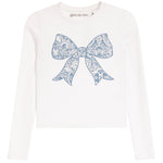 A white long-sleeve crop top featuring a large blue paisley-patterned bow graphic on the front, with the brand name 'girls do too' printed inside the collar.