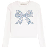 A white long-sleeve crop top featuring a large blue paisley-patterned bow graphic on the front, with the brand name 'girls do too' printed inside the collar.