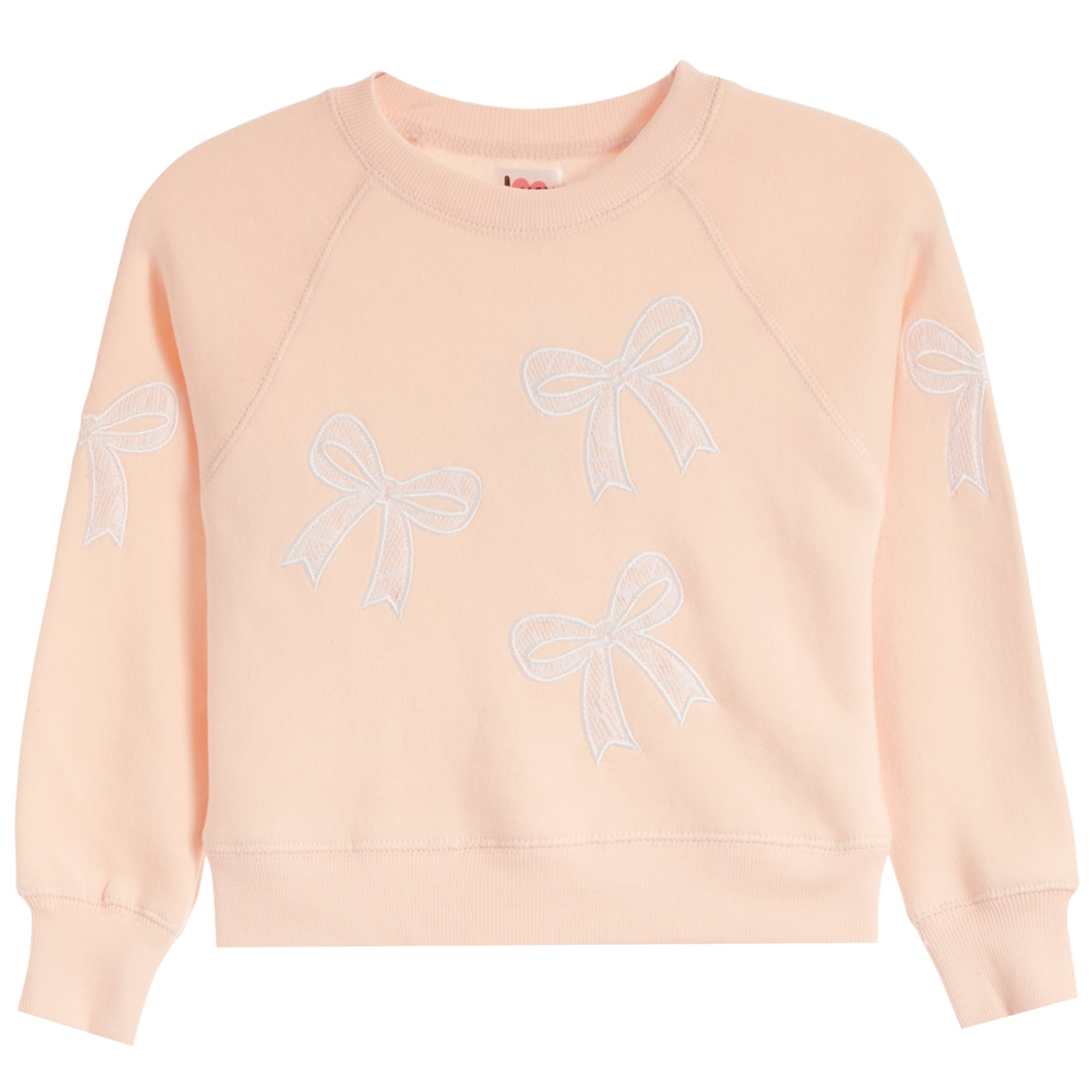 A light peach-pink crewneck sweatshirt featuring embroidered white bow patterns on the front and sleeves, displayed against a solid white background.