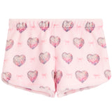 Pink fleece shorts with a repeating pattern of glittery hearts and small bows.