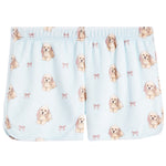 Light blue baby shorts with an all-over print of Cocker Spaniel dogs and small pink bows, featuring an elastic waistband.