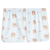 Light blue baby shorts with an all-over print of Cocker Spaniel dogs and small pink bows, featuring an elastic waistband.