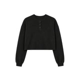 A black long-sleeve cropped henley sweatshirt with three buttons on the chest, displayed flat against a solid white background.