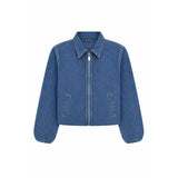 A cropped blue denim jacket with a full front zipper, pointed collar, and two vertical welt pockets on the front, shown against a plain white background.