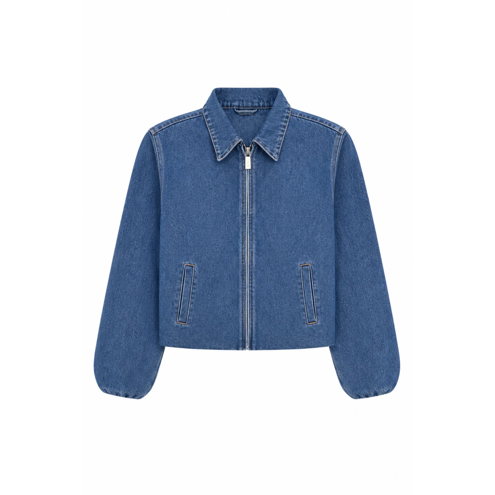 A cropped blue denim jacket with a full front zipper, pointed collar, and two vertical welt pockets on the front, shown against a plain white background.