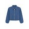 A cropped blue denim jacket with a full front zipper, pointed collar, and two vertical welt pockets on the front, shown against a plain white background.
