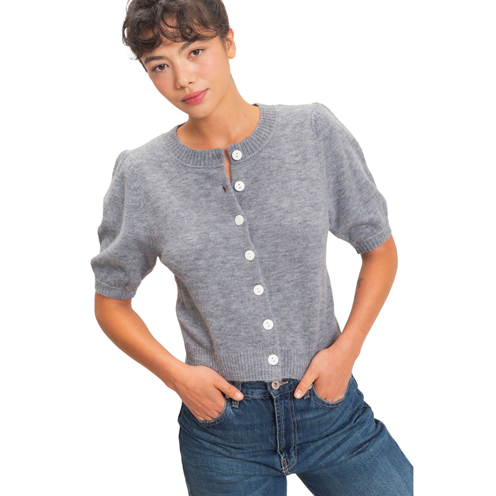 A woman wearing a gray short-sleeve knit cardigan with white buttons down the front, paired with blue jeans, against a plain white background.