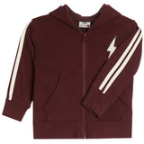 A kids' zip-up hoodie in maroon with cream-colored double stripes on the sleeves and a cream lightning-bolt graphic on the left chest, shown against a plain white background.