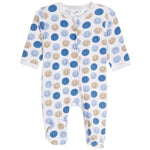 A baby footed sleeper with long sleeves and an all-over pattern of blue and beige smiley faces on a white background.
