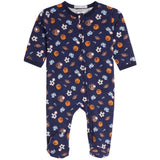 A baby's long-sleeve footed sleeper in navy blue, featuring an all-over print of sports balls and gloves in orange, brown, white, and light blue. The sleeper has a front zipper and is shown flat against a white background.