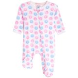 A baby footed sleeper with long sleeves and an all-over print of pink and blue smiley faces on a white background.