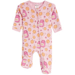 A pink baby footed sleeper with an all-over print of chocolate chip cookies, milk cartons, and pink stars. The sleeper features a zip closure down the front and is shown against a plain white background.