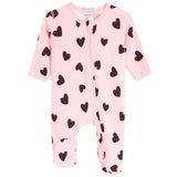 A pink footed sleeper with an all-over black heart pattern, featuring a front zipper and long sleeves and legs, shown on a plain white background.