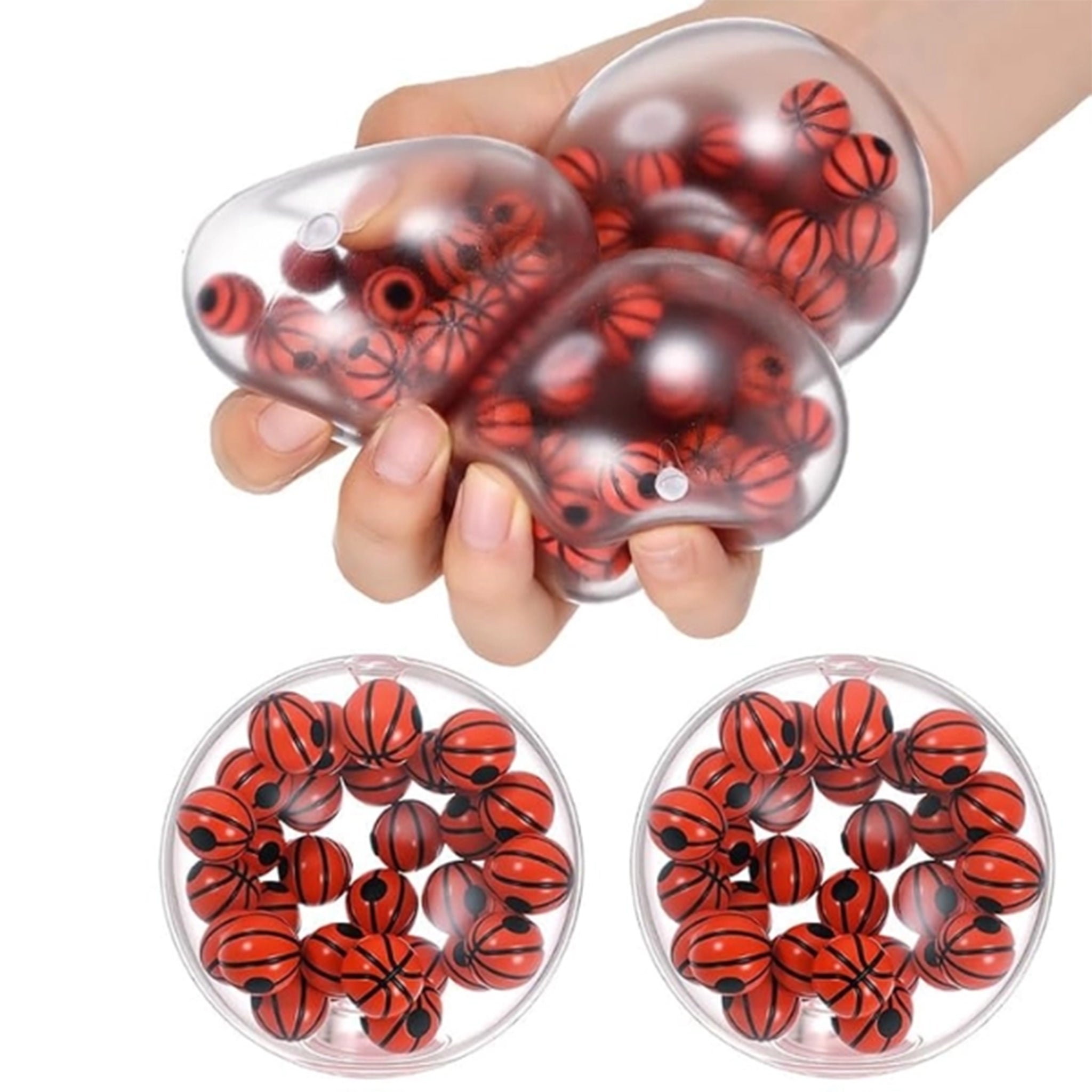 A hand squeezes a clear, basketball-shaped stress ball filled with small red and black basketballs. Two round clear containers filled with more of the same basketball-filled stress balls are shown below on a white background.