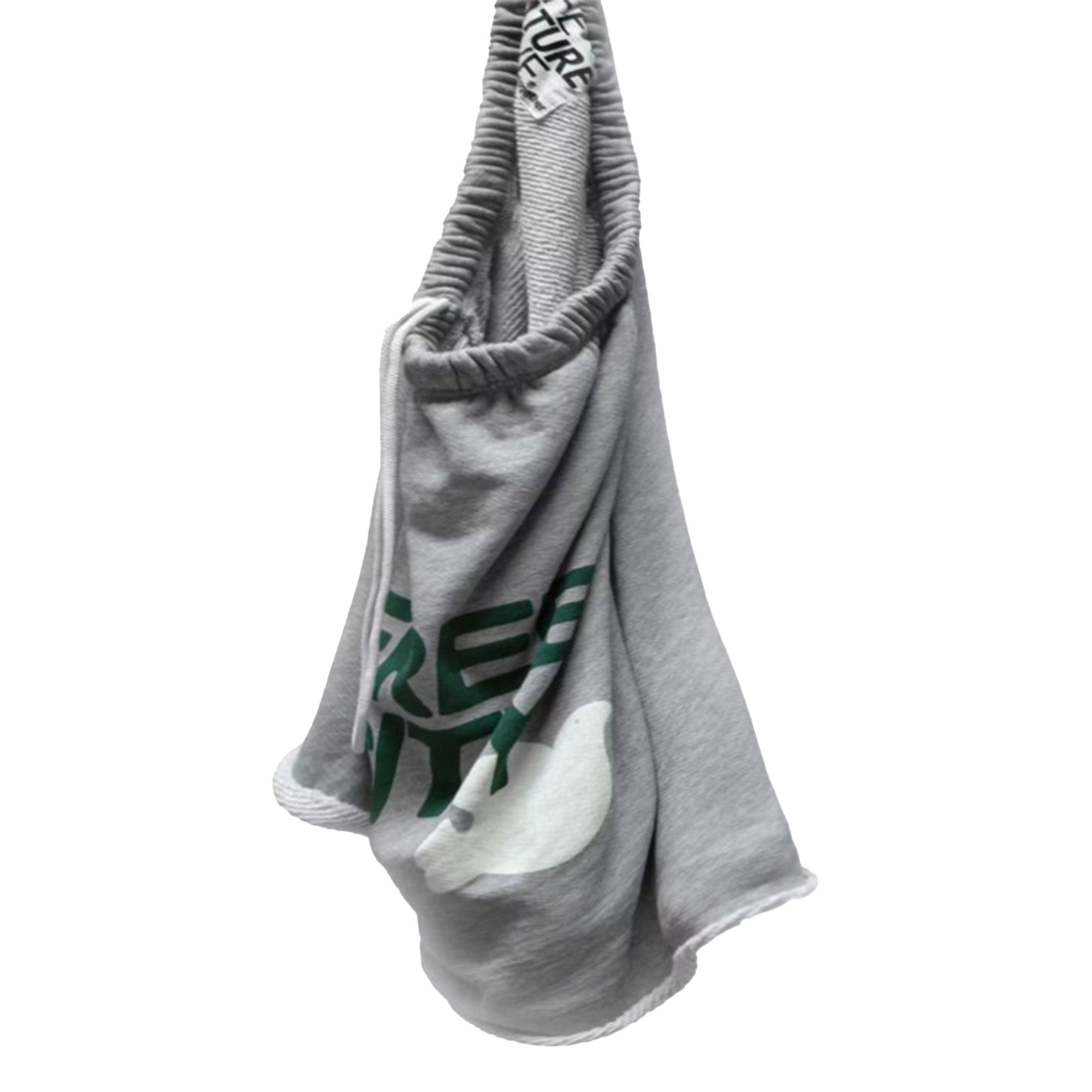 A gray shorts with a green and white graphic print, featuring a drawstring strap with 'FREE CITY' printed on it, set against a plain white background.