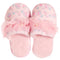 A pair of pink slip-on slippers with a soft floral pattern, featuring a large ruffled pink bow across the top with small pearl-like accents, set against a plain white background.