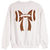A light heather gray crewneck sweatshirt featuring a large brown graphic of a football tied in a bow on the back.