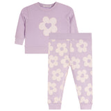 A two-piece set in light lavender, featuring a long-sleeve top with a large cream flower and heart motif on the chest, and matching patterned pants.