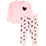 A children's two-piece set in light pink, featuring a long-sleeve top with a black heart on the chest and matching pants with an all-over black heart pattern.