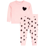 A children's two-piece set in light pink, featuring a long-sleeve top with a black heart on the chest and matching pants with an all-over black heart pattern.