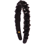 A black velvet headband embellished with black sequins and faux flowers, shown against a plain white background.