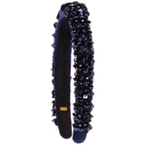 A dark navy blue velvet headband embellished with black sequins and beads, shown against a plain white background.