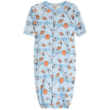 A baby long-sleeve sleep sack with a light blue watercolor background and an all-over sports-themed print featuring basketballs, footballs, soccer balls, and whistles. The sleep sack has a snap-button front and elastic cuffs.