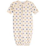 A baby sleep sack with short sleeves, a front zipper, and an all-over star pattern in blue and tan on a cream background.
