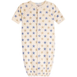A baby sleep sack with short sleeves, a front zipper, and an all-over star pattern in blue and tan on a cream background.