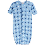 A baby long-sleeve footless sleeper in light blue with an all-over star print in navy and white, featuring a snap-button front closure.