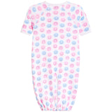 A baby long-sleeve footless sleeper with an all-over pattern of pink and blue smiling face emojis on a white background.