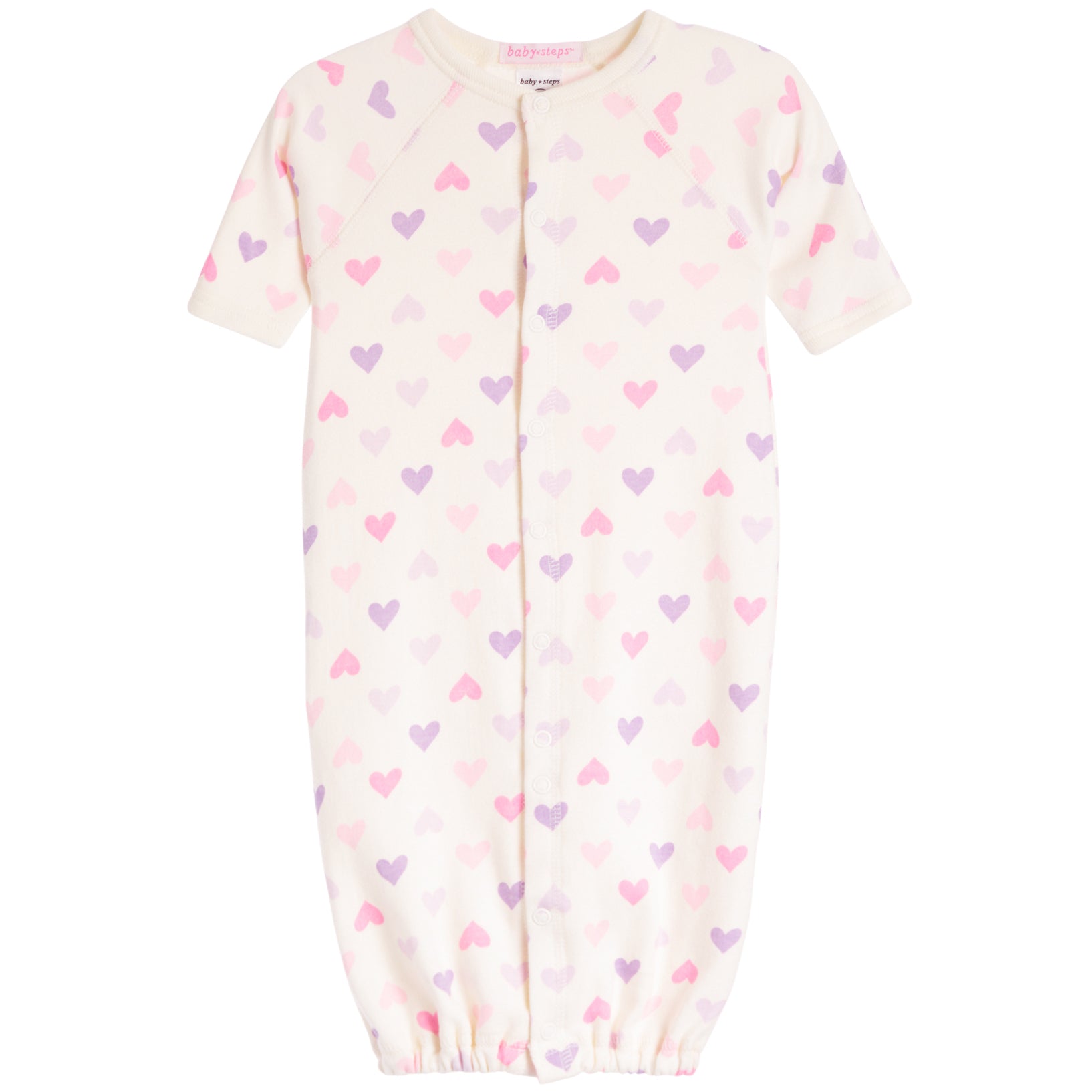 A baby sleep sack in cream with an all-over pattern of small pink and purple hearts, featuring short raglan sleeves and a front snap closure.