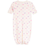 A baby long-sleeve footless one-piece sleeper in cream with an all-over pattern of small pink and purple hearts, shown against a plain white background.