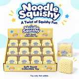 Noodle Squishy collectible soft touch toys displayed in a yellow retail box with a clear sample pack and one loose noodle toy on a light blue and white background with the Noodle Squishy logo.