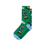 A pair of green crew socks featuring a repeating pattern of cartoon goats wearing yellow and green hats, with light blue toes and heels, shown on a plain white background.