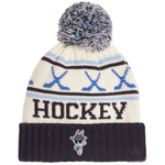 A cream-colored knit hockey beanie with a navy blue pom-pom, featuring blue crossed hockey sticks, the word 'HOCKEY' in navy, and a navy blue ribbed cuff with a small team logo.