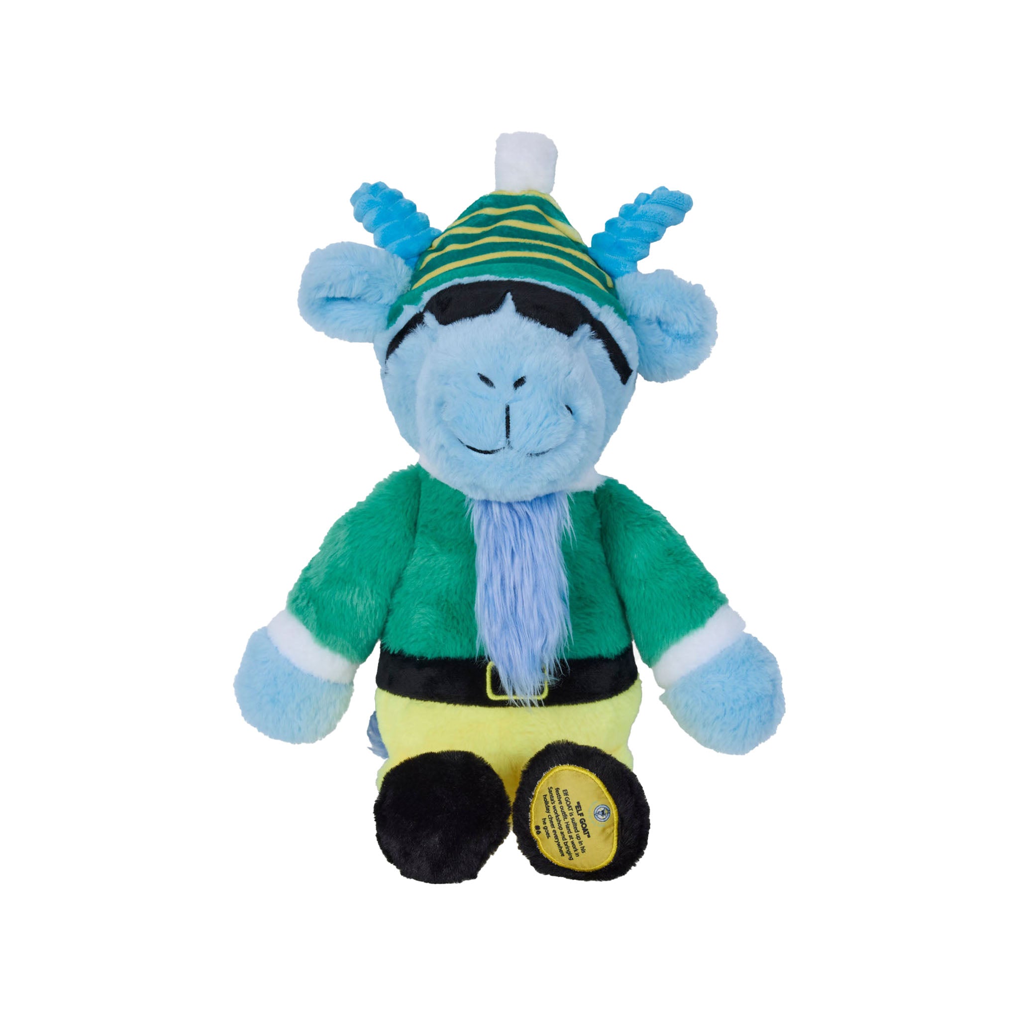 A plush toy goat with a light blue face and ears, wearing a green and yellow striped hat, a green tunic, a yellow belly, and black shoes, photographed on a plain white background.