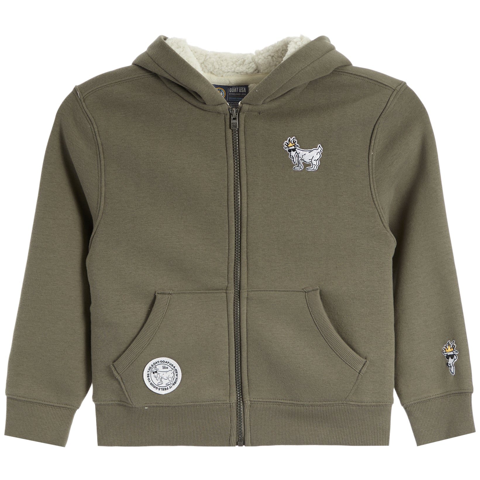An olive green zip-up hoodie for kids, featuring a cream sherpa-lined hood, front pockets, a small embroidered goat mascot on the left chest, a circular patch on the right pocket, and a small sleeve patch.