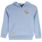 A light blue hooded sweatshirt with a small embroidered goat graphic on the left chest and a circular patch on the lower left front pocket, shown against a plain white background.