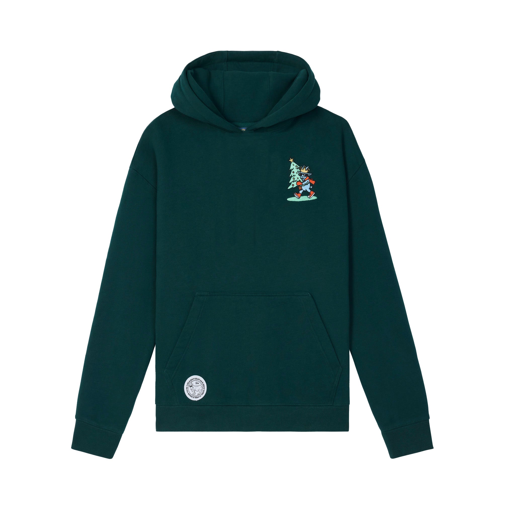 A dark green pullover hoodie with a small embroidered character under a Christmas tree on the left chest and a circular patch on the front pocket, shown against a plain white background.
