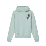 A light mint green pullover hoodie with a kangaroo pocket, featuring a small colorful graphic on the left chest and a circular logo patch on the lower left front, displayed against a solid white background.