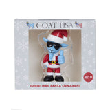 Goat USA Christmas Santa ornament in its original window box packaging. The ornament depicts a blue goat dressed in a red and white Santa suit, black sunglasses, and giving a thumbs-up.