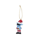 A small hanging Christmas ornament featuring a blue cartoon character wearing a red Santa hat, red Santa outfit, black sunglasses, and black boots, suspended by a gold string on a plain white background.