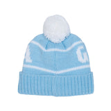 A light blue knit pom-pom beanie with white stripes and large white knit letters on the sides, shown against a plain white background.