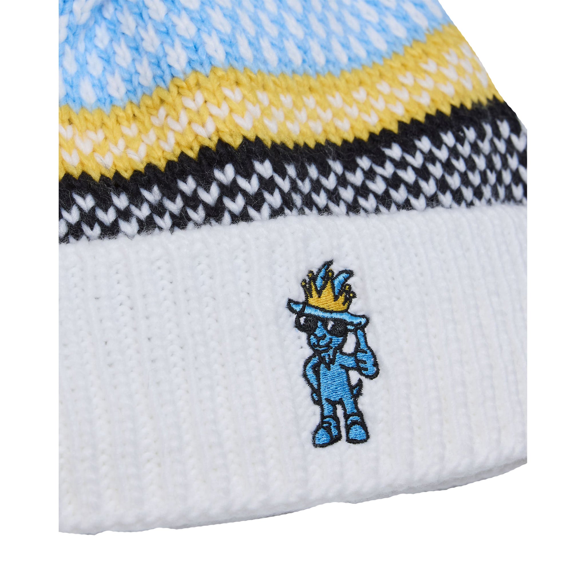 Close-up of a white knit beanie with a blue and yellow embroidered cartoon character on the front, showing the striped knit pattern above.