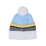 A knit pom-pom beanie hat featuring a light blue and white patterned top section, a yellow stripe, a black and white patterned band, and a solid white ribbed cuff with a white pom-pom on top, shown against a plain white background.