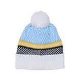 A knit pom-pom beanie hat featuring a light blue and white patterned top section, a yellow stripe, a black and white patterned band, and a solid white ribbed cuff with a white pom-pom on top, shown against a plain white background.