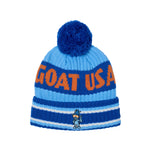 A blue and light blue knit beanie hat with a dark blue pom-pom, featuring the text 'GOAT USA' in orange and a small goat mascot logo near the cuff.